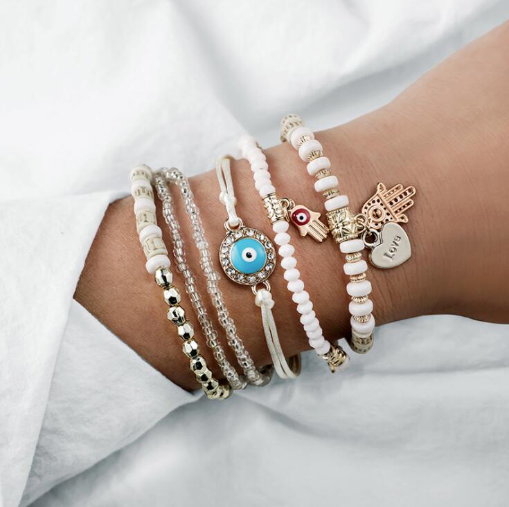 Elegant women's protective evil eye bracelet set. Symbolic silver tone jewelry for spiritual fashion & good luck.