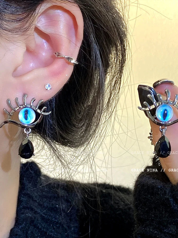 Elegant women's protective silver Evil Eye drop earrings, a mystical dangle design for spiritual style and good luck.