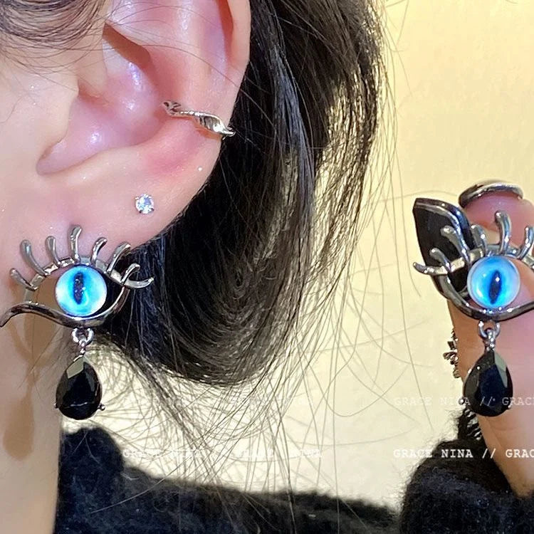Mystical silver Evil Eye drop earrings for women, offering spiritual protection and an elegant touch to any outfit.