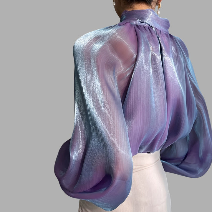 Feminine elegant puff sleeve blouse for women. Stylish long sleeve top for versatile fashion.