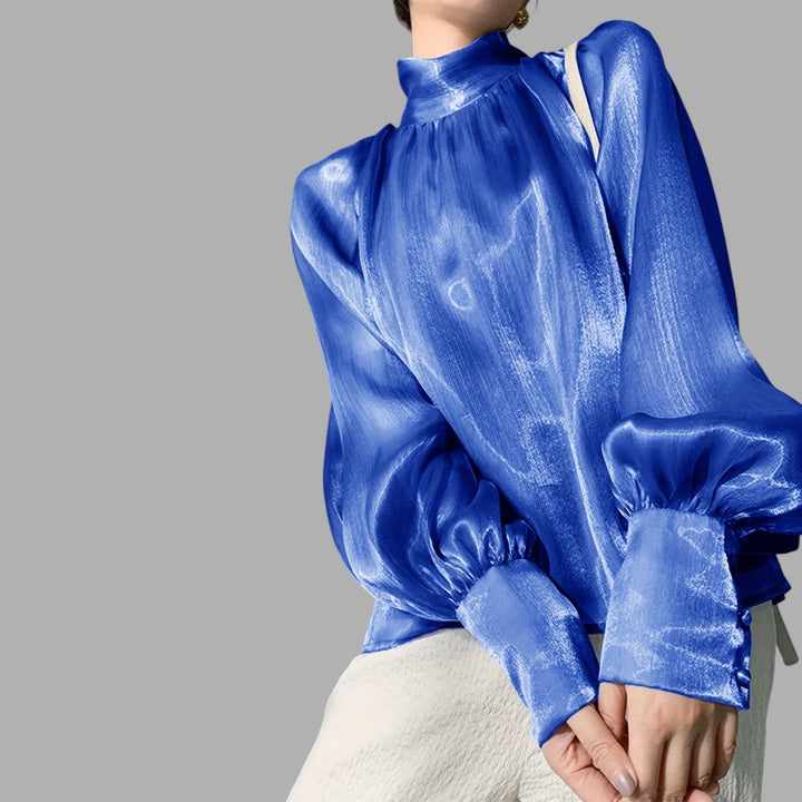 Stylish women's blouse with elegant puff sleeves. Fashionable long sleeve top for women.