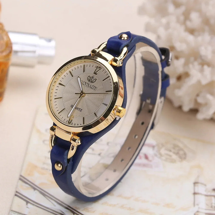 Minimalist women's fashion watch, quartz movement, with a refined silver case and a black vegan leather strap.