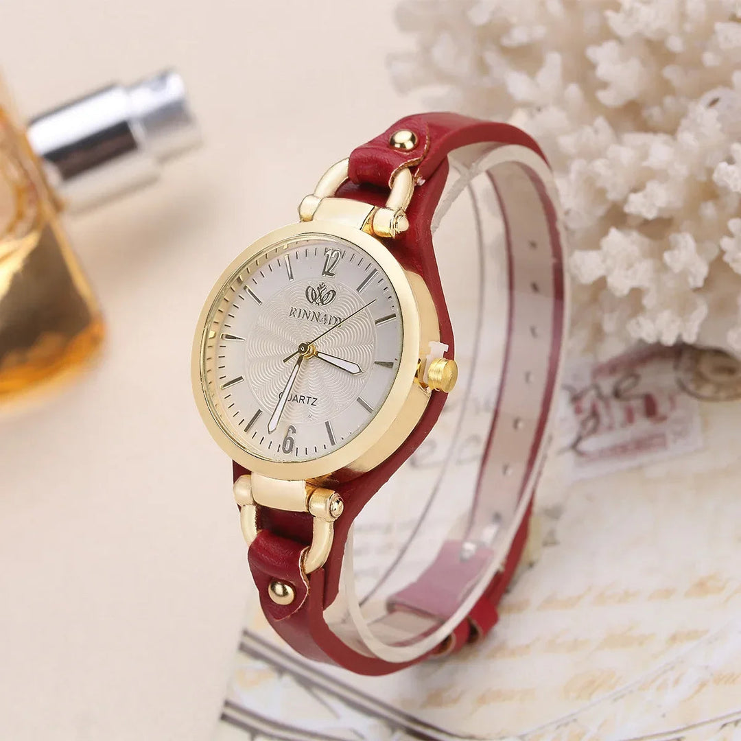Close-up of a women's elegant quartz timepiece featuring a clean white dial and a blue vegan leather strap.