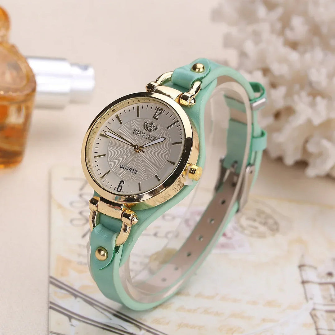 Stylish women's watch on a wrist, showing a gold-tone case and a comfortable beige vegan leather strap.