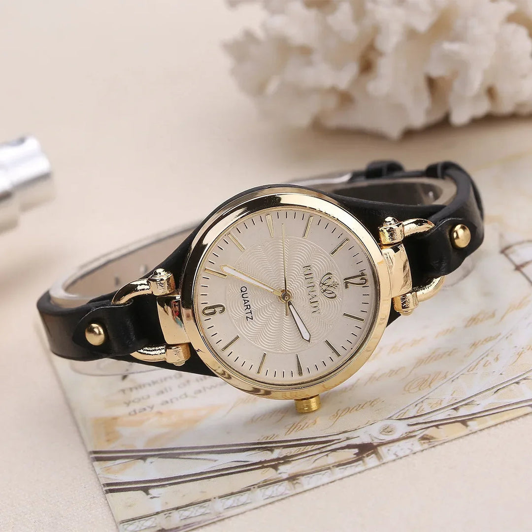 Clear shot of a women's minimalist quartz watch, featuring a silver dial and a comfortable dark green vegan leather strap.