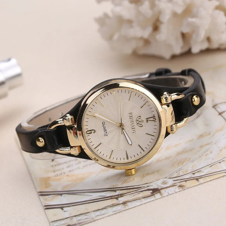 Clear shot of a women's minimalist quartz watch, featuring a silver dial and a comfortable dark green vegan leather strap.