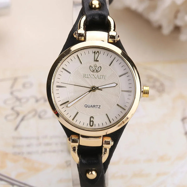Fashionable women's accessory: an elegant quartz watch with a classic round face and a durable black vegan leather strap.