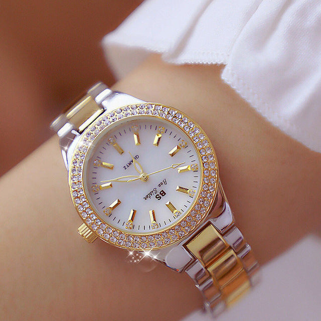 Fashionable women's crystal watch with a shimmering mother-of-pearl dial and sophisticated two-tone design, quartz movement.