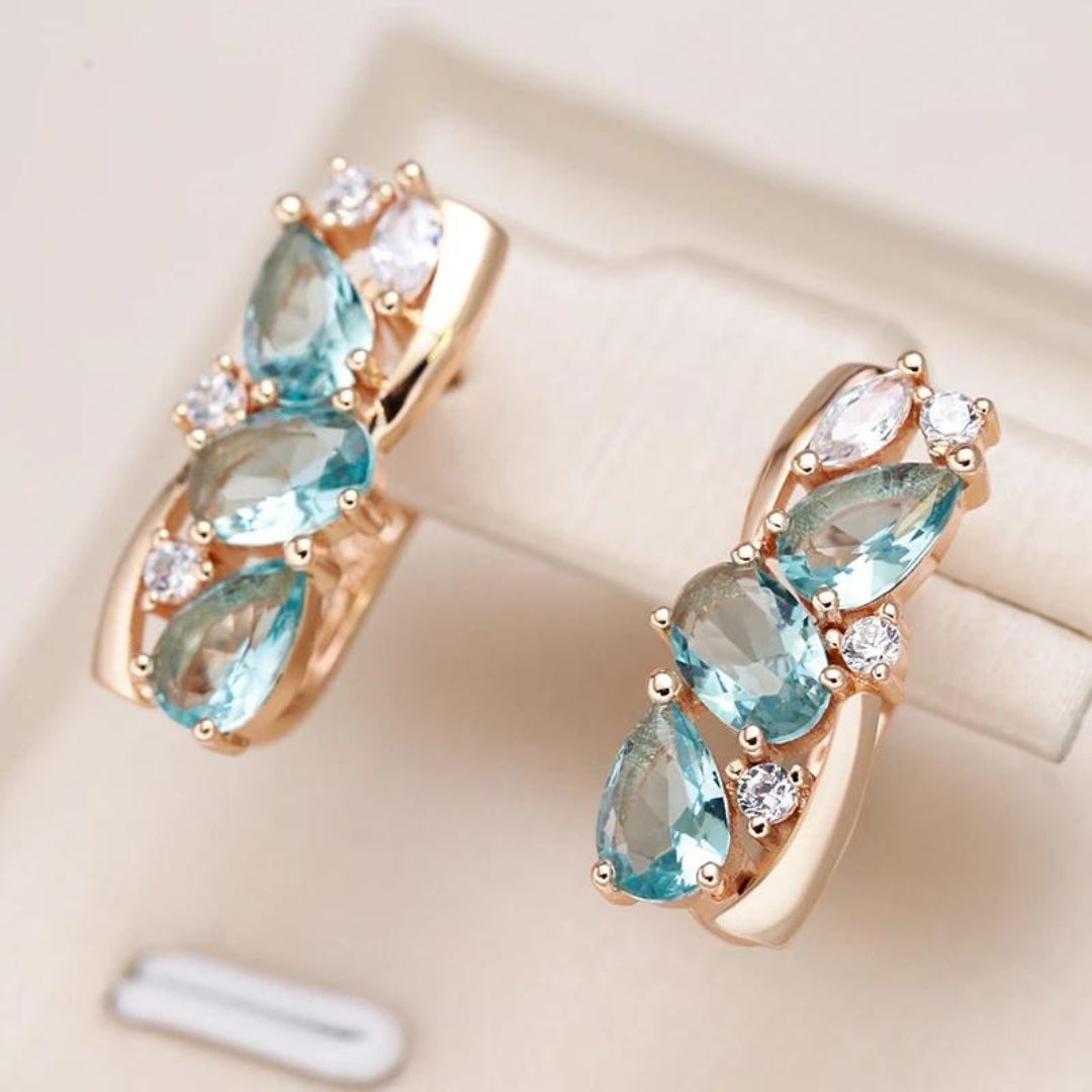 Elegant women's radiant blue zirconia gold drop earrings, a perfect fine jewelry fashion accessory.