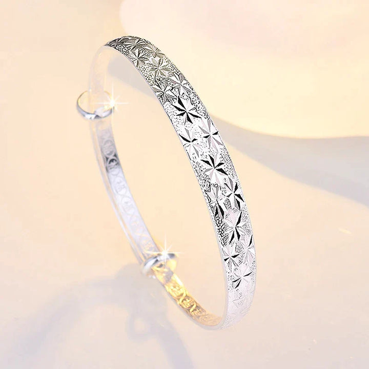 Close-up of an elegant Women's Radiant Star Armband Bracelet, showcasing sterling silver and celestial star details.