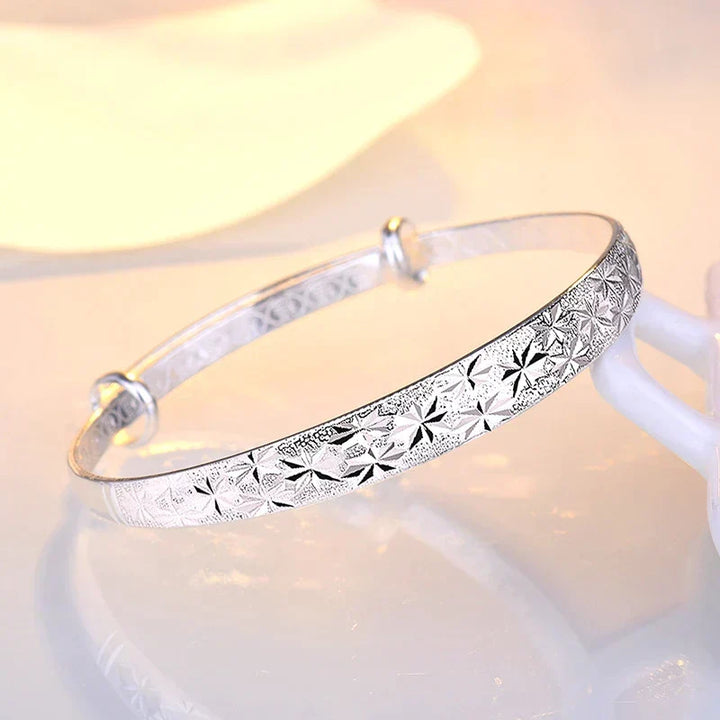 Fashionable women's armband bracelet, sterling silver Radiant Star design, elegant and adjustable celestial jewelry.