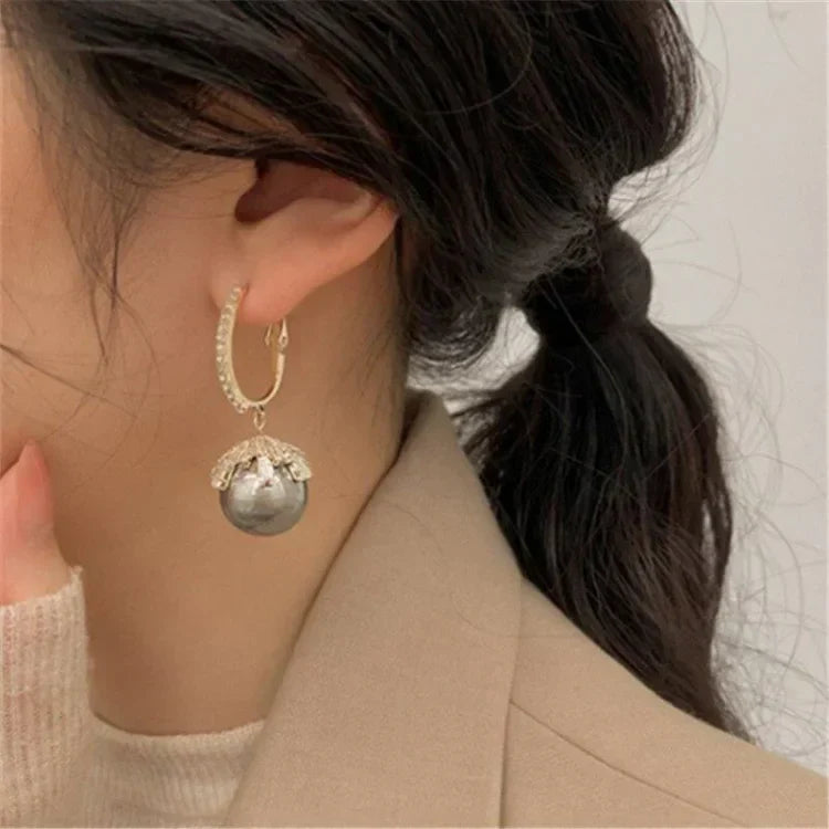 Elegant women's refined pearl drop earrings in a classic silver setting, perfect for timeless style.