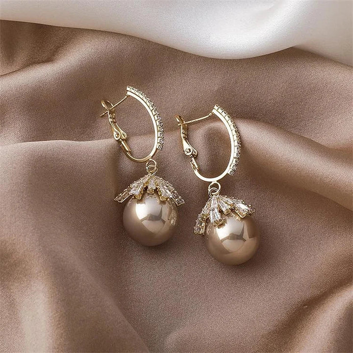 Classic silver pearl drop earrings for women, offering refined elegance and a timeless jewelry statement.