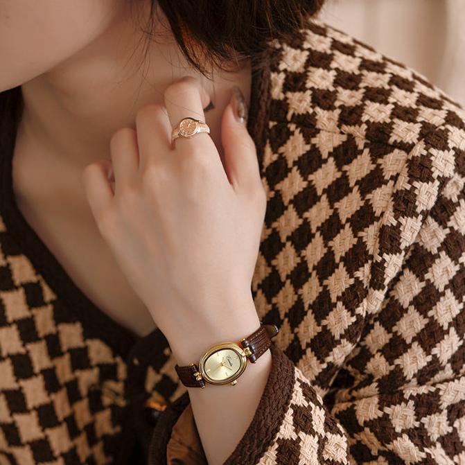 Modern women's refined wristwatch, unique rectangle & oval case, a chic black dial dress timepiece.