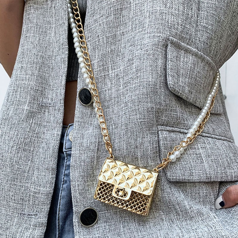 Shimmering metallic mini clutch adorned with sparkling rhinestones, ideal for evening wear.