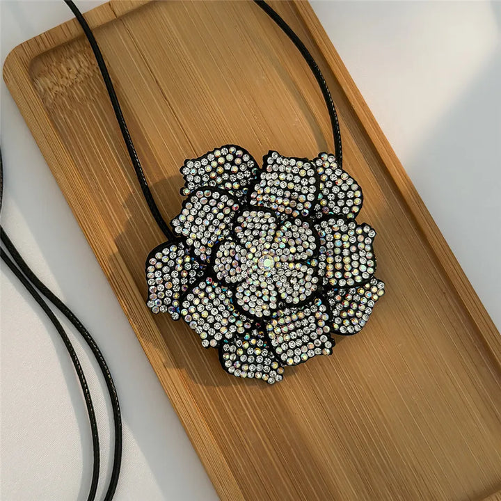 Close-up of a shimmering rhinestone rose choker. Elegant women's fashion necklace with intricate crystal detail.