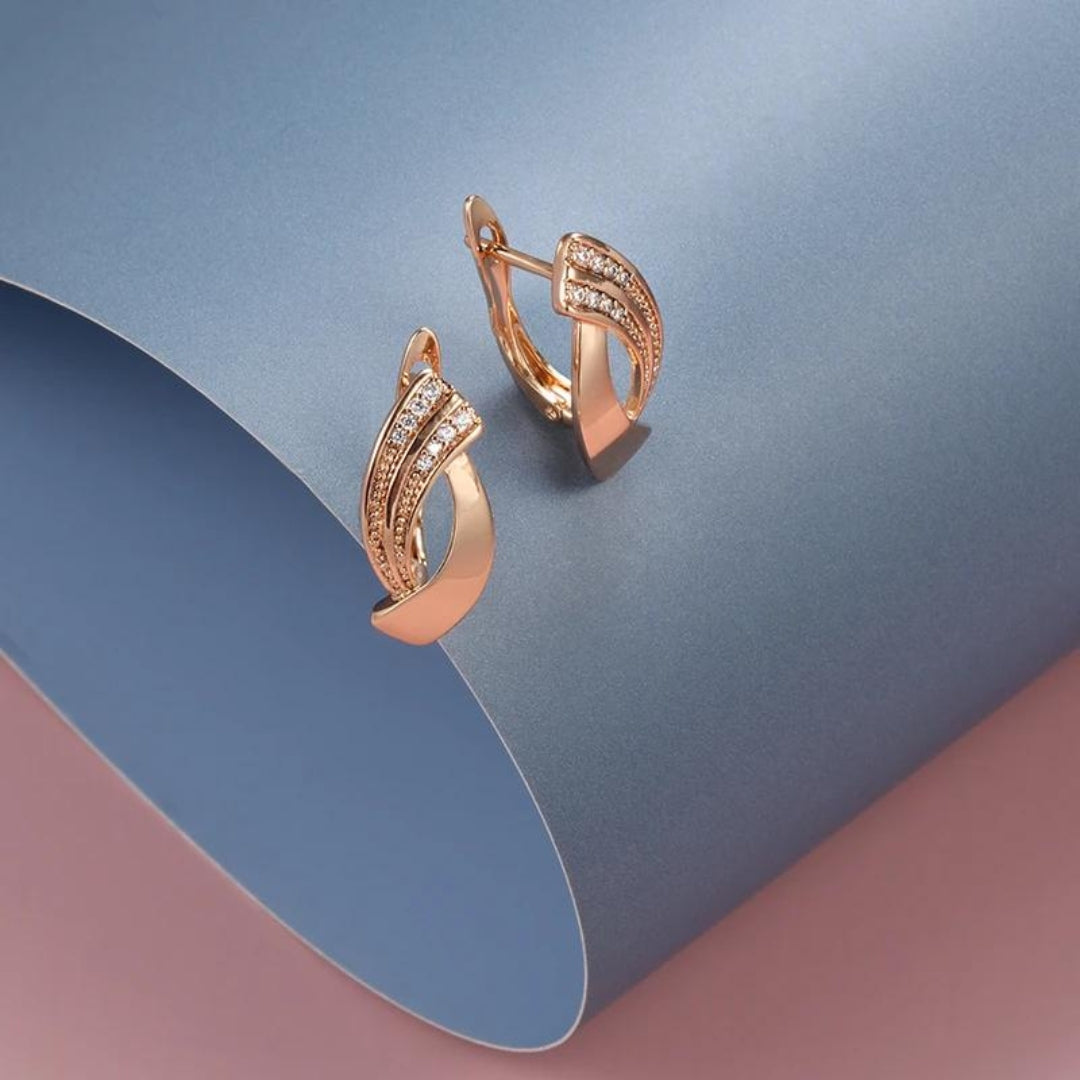 Elegant women's rose gold drop earrings with sparkling zirconia, perfect for special occasions.