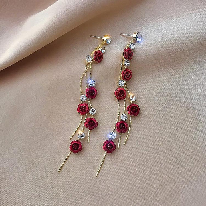 Elegant women's rose waterfall drop earrings. Romantic flower jewelry, perfect accessory for a gift or special event.