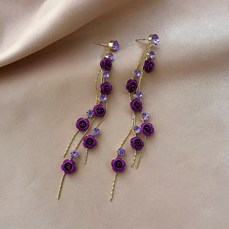 Stylish women's waterfall rose drop earrings. Elegant and romantic accessory, perfect for adding a touch of floral charm.