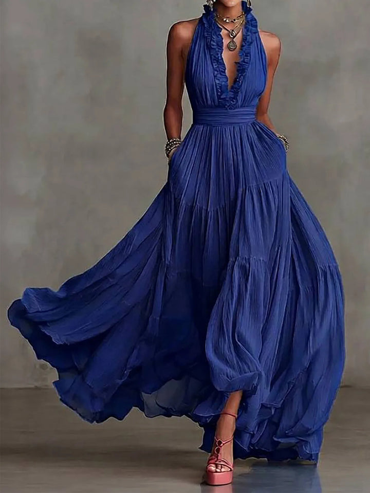 Flowing women's formal evening gown, a backless maxi dress with ruffle trim and graceful pleated skirt.
