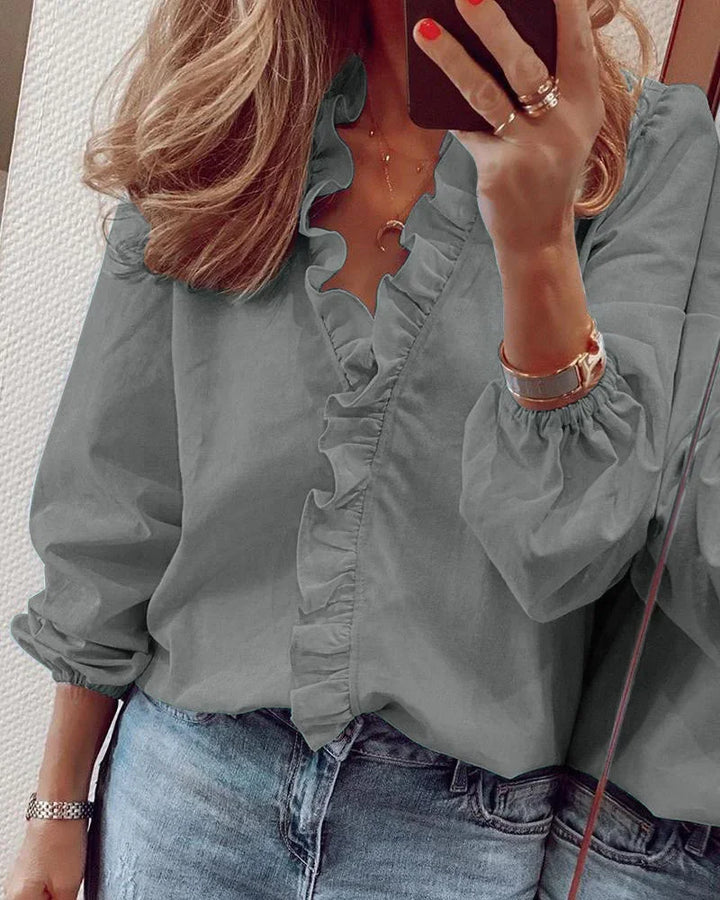 Elegant women's long sleeve V-neck shirt featuring ruffles, a versatile addition to any wardrobe.