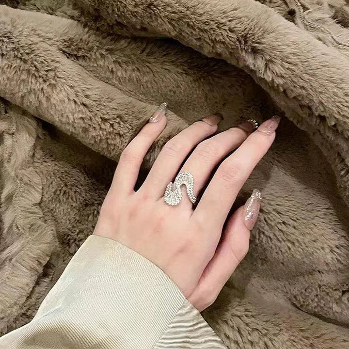 Elegant women's S-shaped silver ring adorned with sparkling zirconia, perfect fashion jewelry for her.