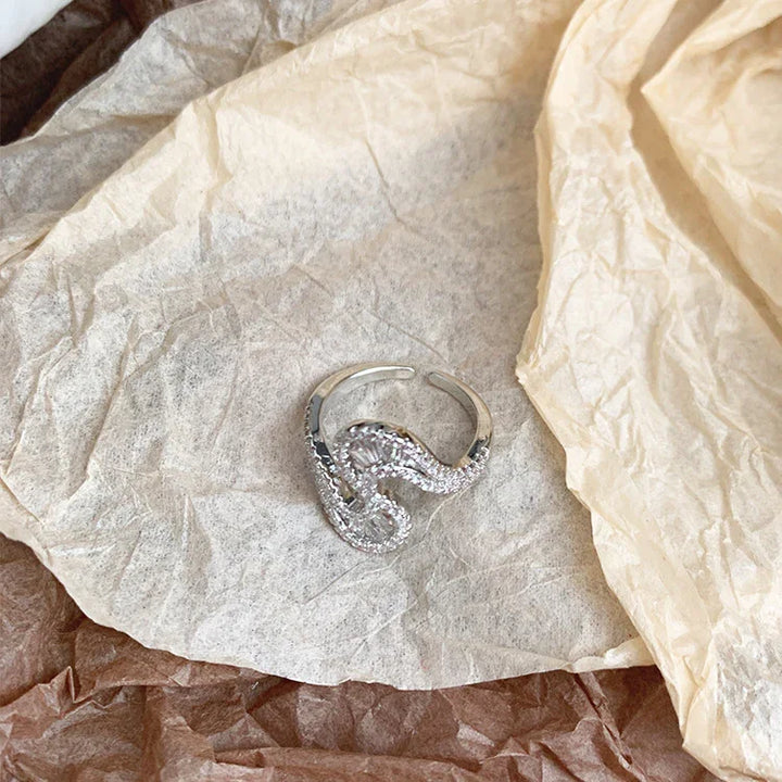 Striking S-shape silver ring for women, featuring brilliant zirconia stones; a unique and elegant statement ring.