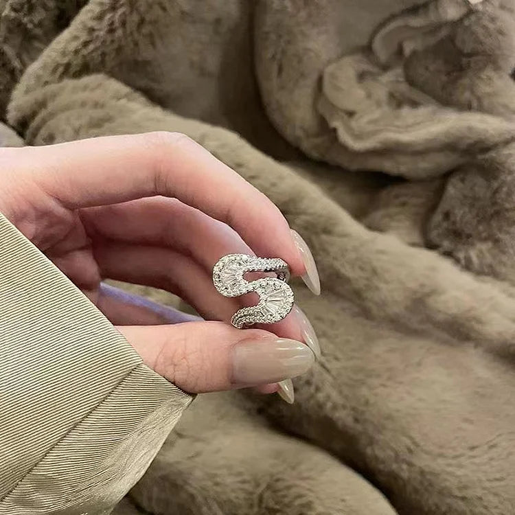 Fashionable women's S-shaped silver ring with intricate zirconia detailing, a chic and elegant accessory.