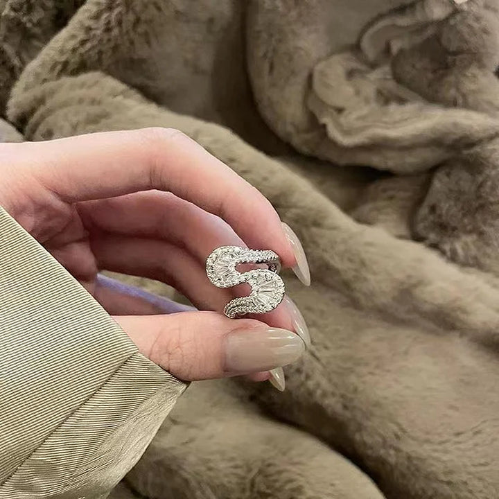 Fashionable women's S-shaped silver ring with intricate zirconia detailing, a chic and elegant accessory.