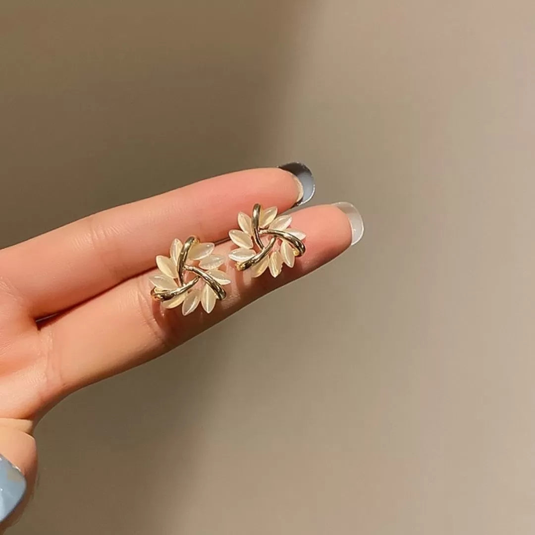 Model wearing delicate Sakura Blossom Opal stud earrings, highlighting their subtle sparkle and floral charm.