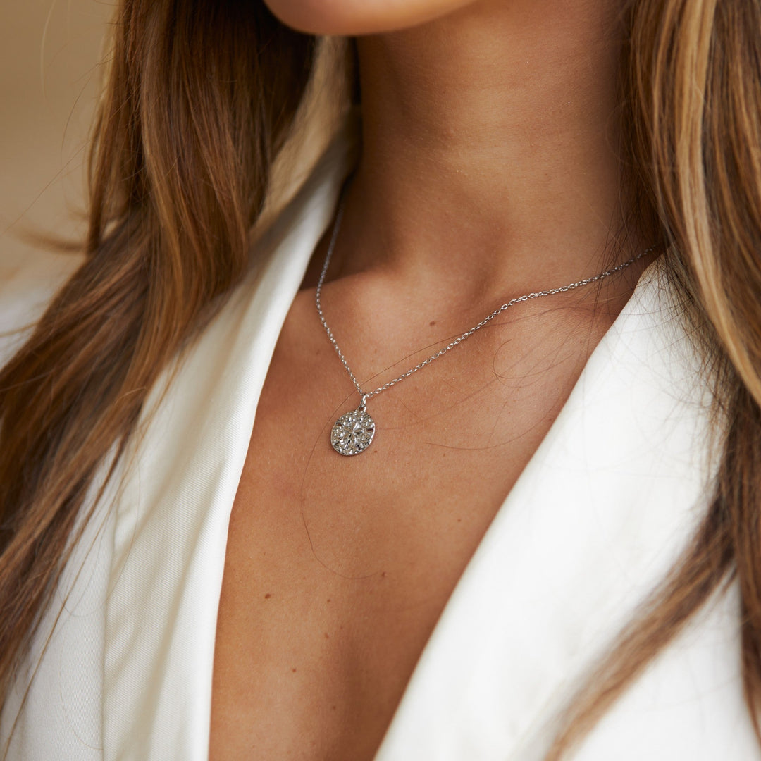 Coastal sand dollar charm necklace for women, an elegant and hypoallergenic ocean-inspired gift idea.