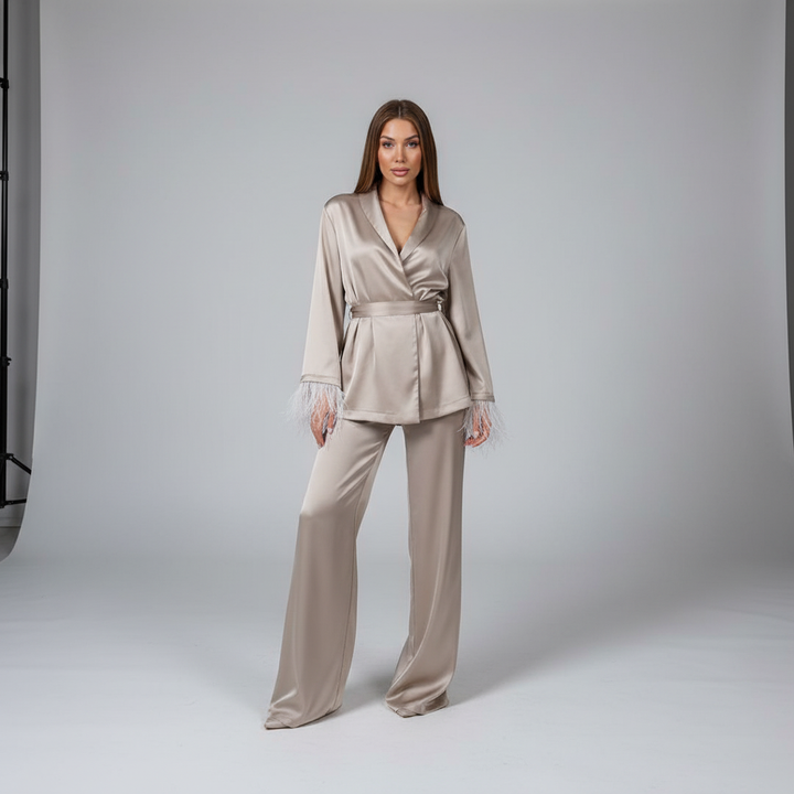 Close-up of a luxurious feather-trimmed satin top, part of an elegant women's lounge set.