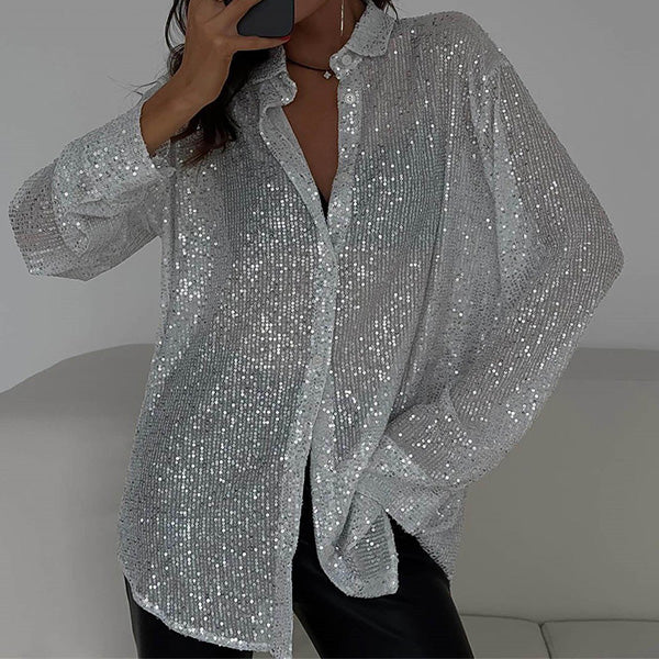 Woman models a sparkling loose sequin blouse, perfect for a chic party look or special occasion. Glamorous.
