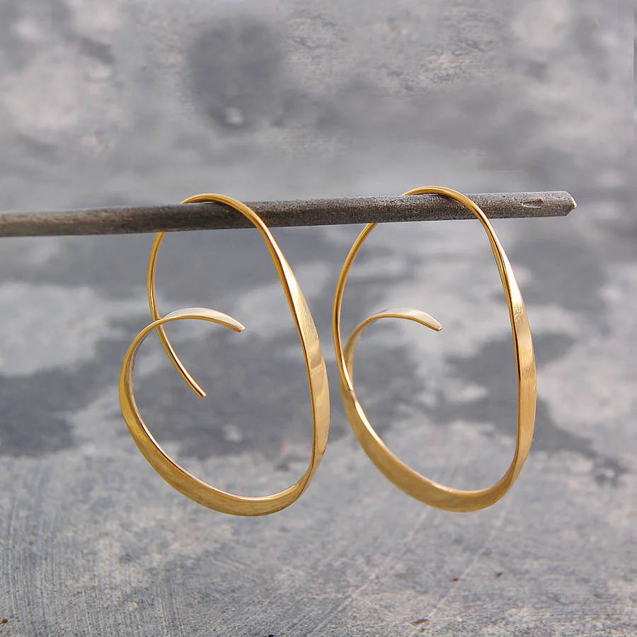 Modern women's Serina spiral dangle earrings. Artistic design in polished silver, elegant statement jewelry.