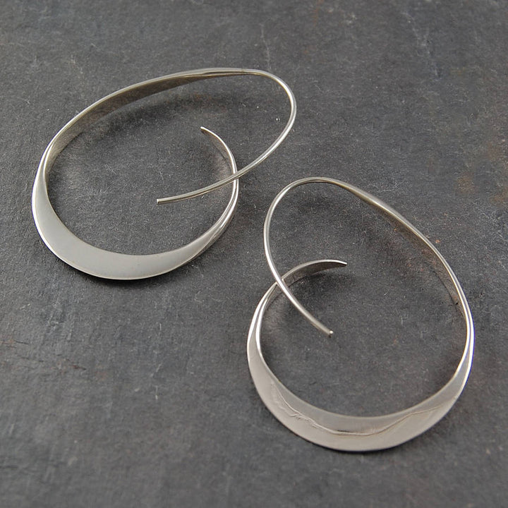 Serina spiral dangle earrings for women. Unique artistic jewelry with a modern twist, available in gold & silver.