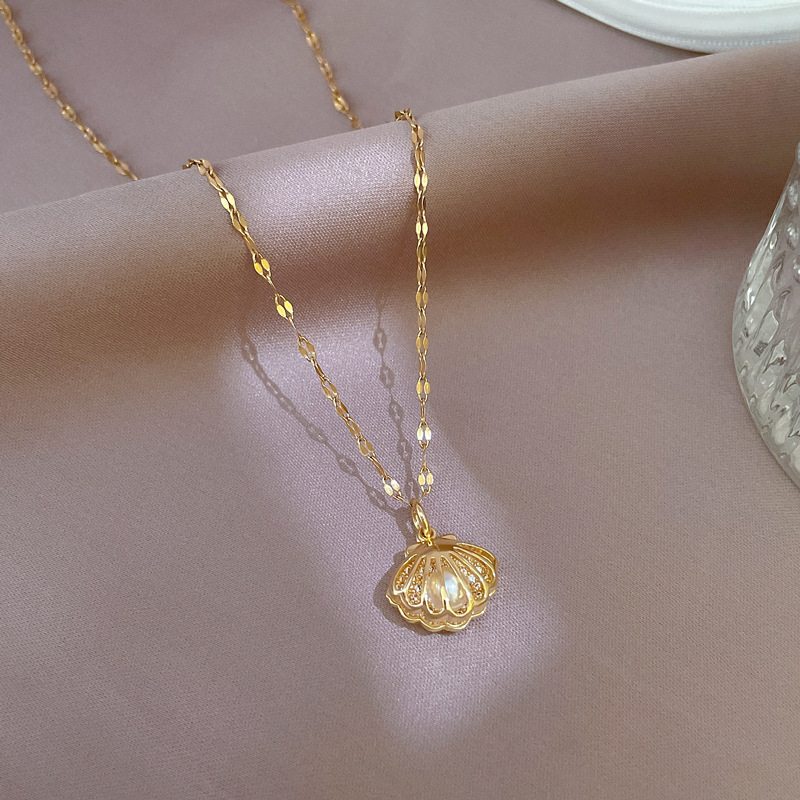 Timeless gold plated shell pearl necklace for women, elegant pearl jewelry with oceanic charm, perfect for any occasion.