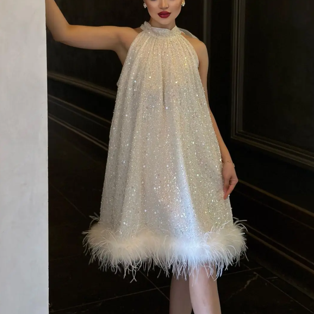 Elegant women's shimmering sequined feather evening dress, perfect for glamorous parties & special occasions.