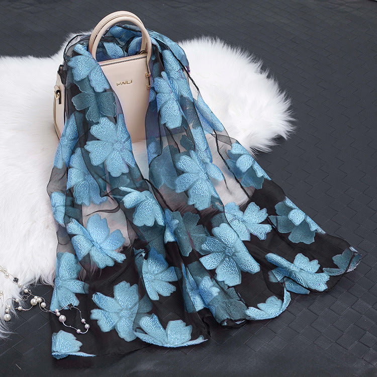Luxurious women's floral silk scarf with unique cut-out detailing.