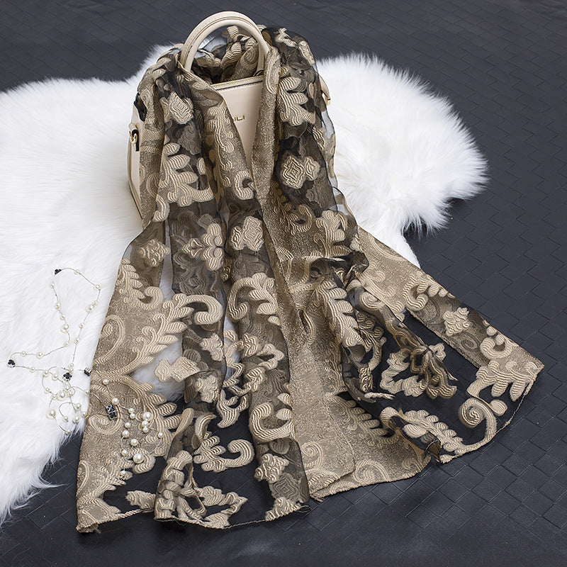 Trendy women's organza blend scarf, featuring a floral cut-out design.