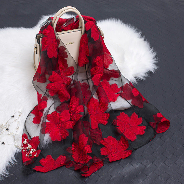 Elegant women's lightweight silk floral scarf with striking cut-out details.