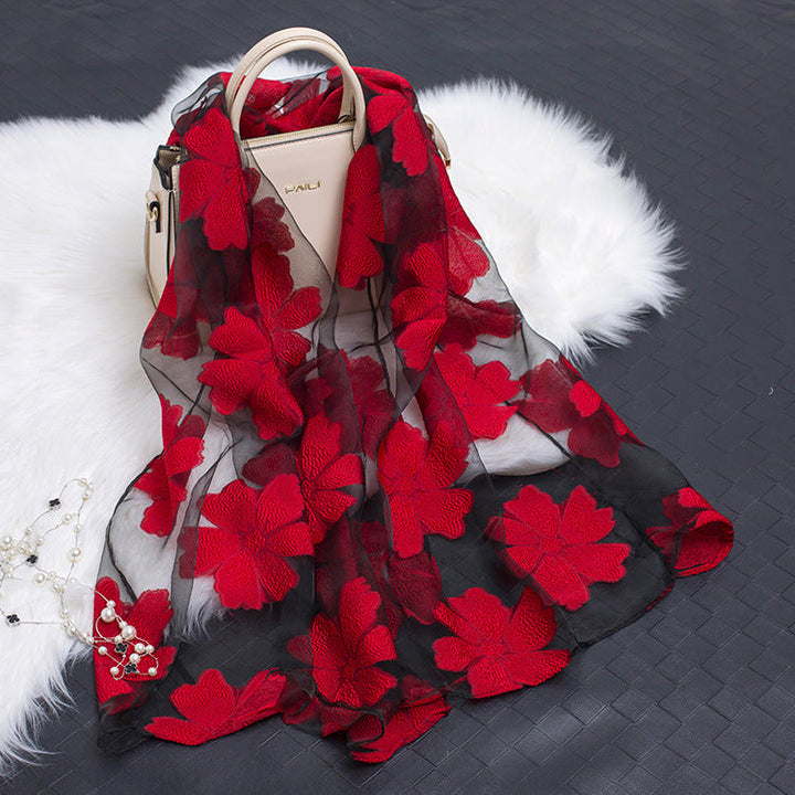 Elegant women's lightweight silk floral scarf with striking cut-out details.