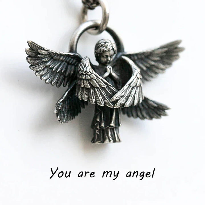 Detailed silver angel wing necklace, an elegant women's jewelry item perfect as a gift.