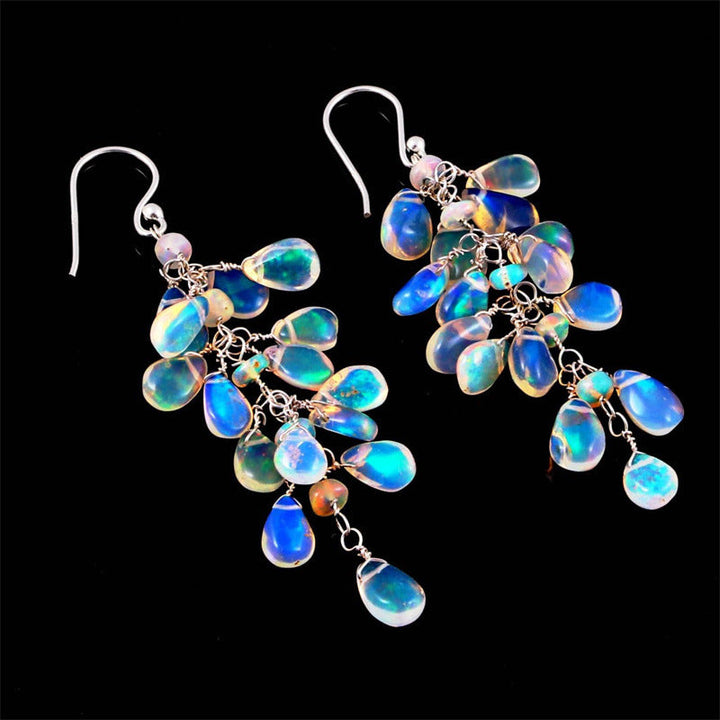Celestial women's moonstone drop earrings, featuring shimmering natural gemstones set in artisan silver jewelry.