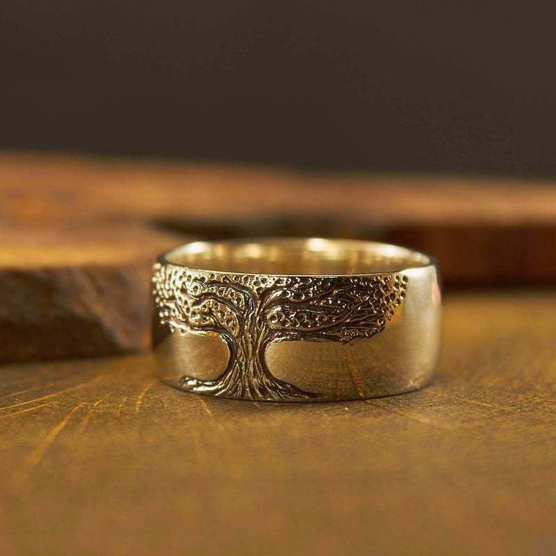 Close-up of a women's elegant Tree of Life ring, showcasing its intricate silver and gold nature-inspired design.