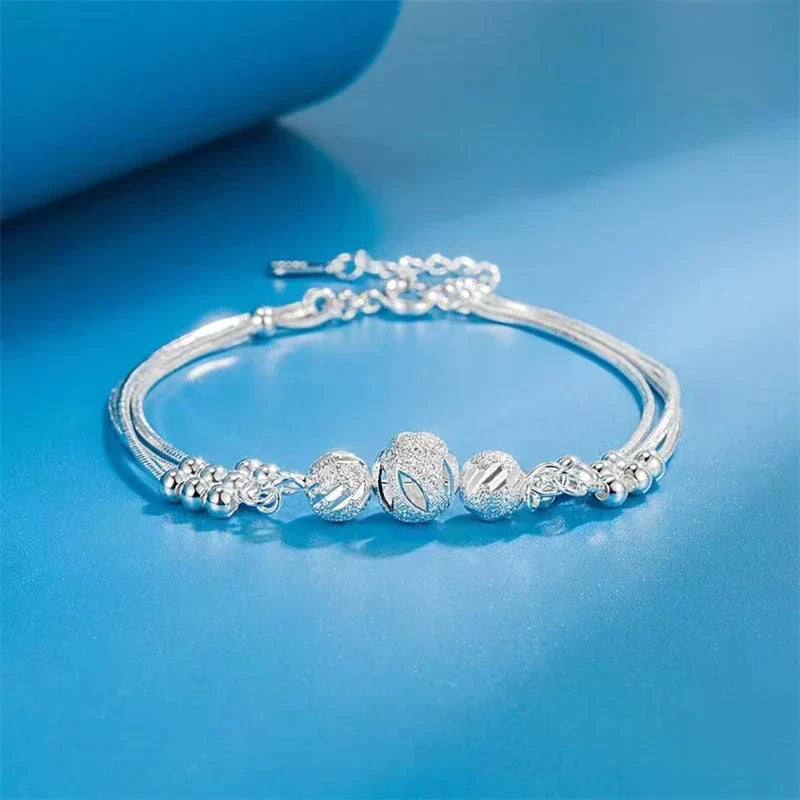 Close-up of an elegant silver pearl bracelet, adjustable, featuring lustrous natural pearls. Women's versatile jewelry.