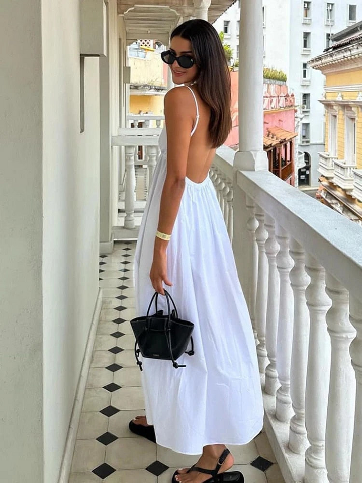 Elegant women's sleeveless black maxi dress with deep V-neck and open back, perfect for evening wear.