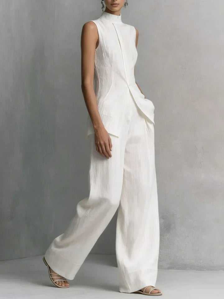 Modern women's sleeveless jumpsuit featuring a high neck and flowing wide leg design, ideal for an elegant look.