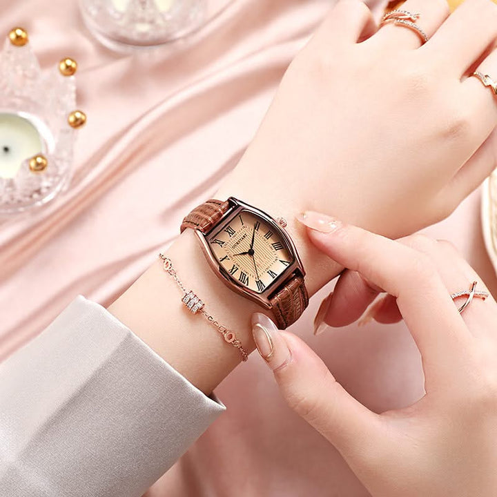 Women's elegant dress watch with classic Roman numerals, complementing a stylish outfit for a sophisticated look.