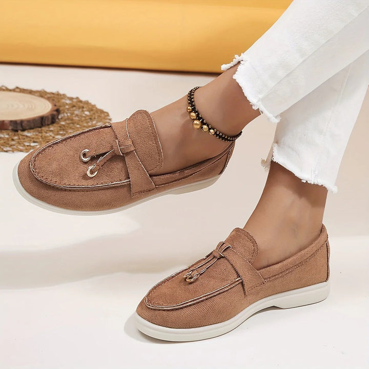 Elegant women's slip-on loafers with chic tassel detail. Comfortable and versatile for classic everyday style.