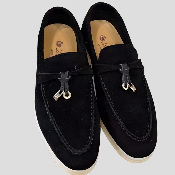 Detailed view of the stylish tassels on classic women's slip-on loafers, highlighting elegant design.